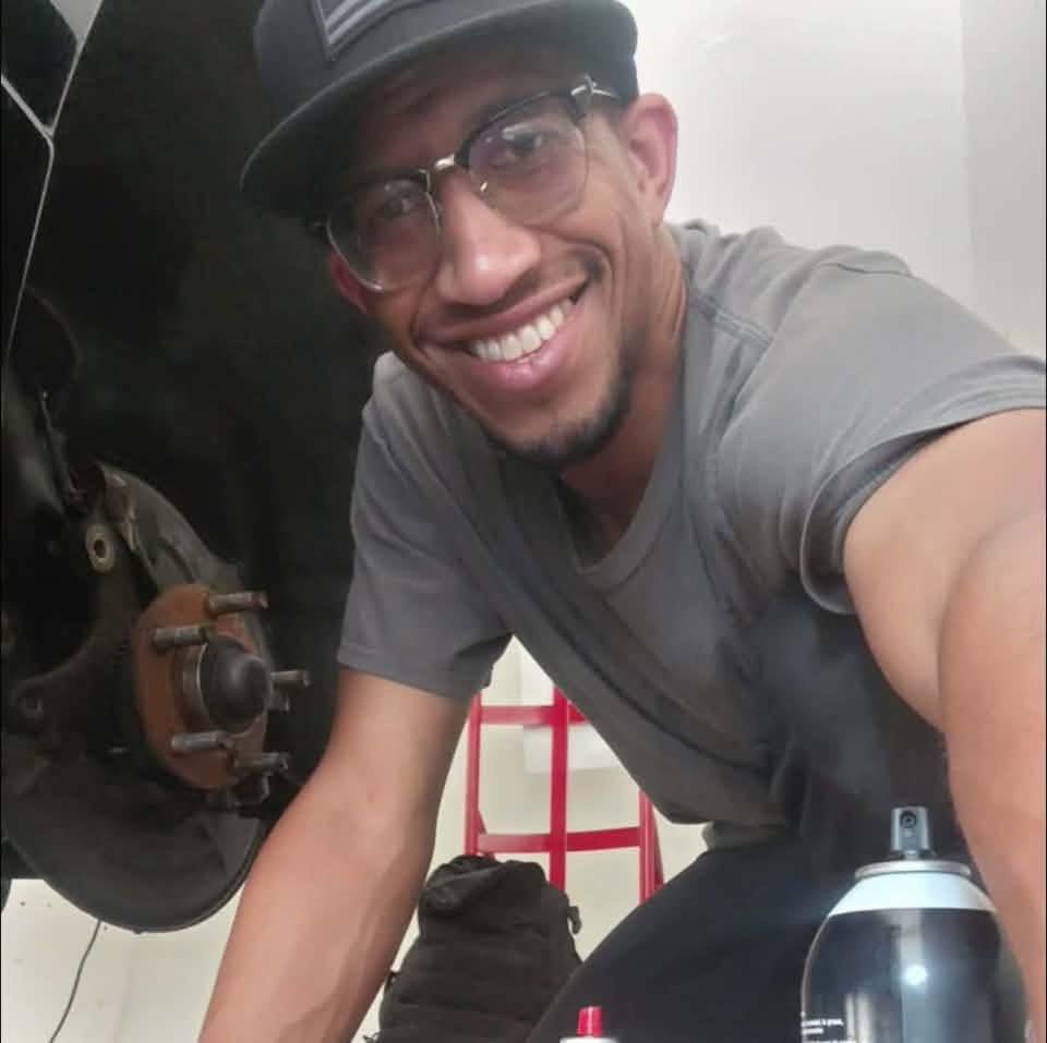 Dan, certified mobile mechanic, working on a vehicle
